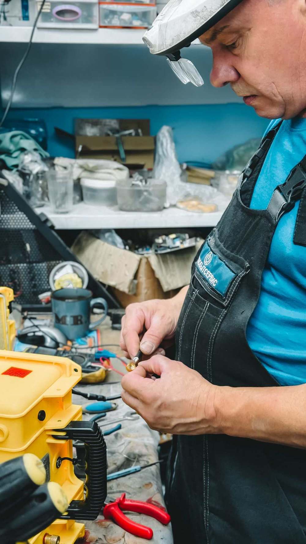 Technician repairing machinery parts in a repair workshop